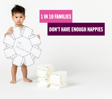 Baby with unused stack of nappies